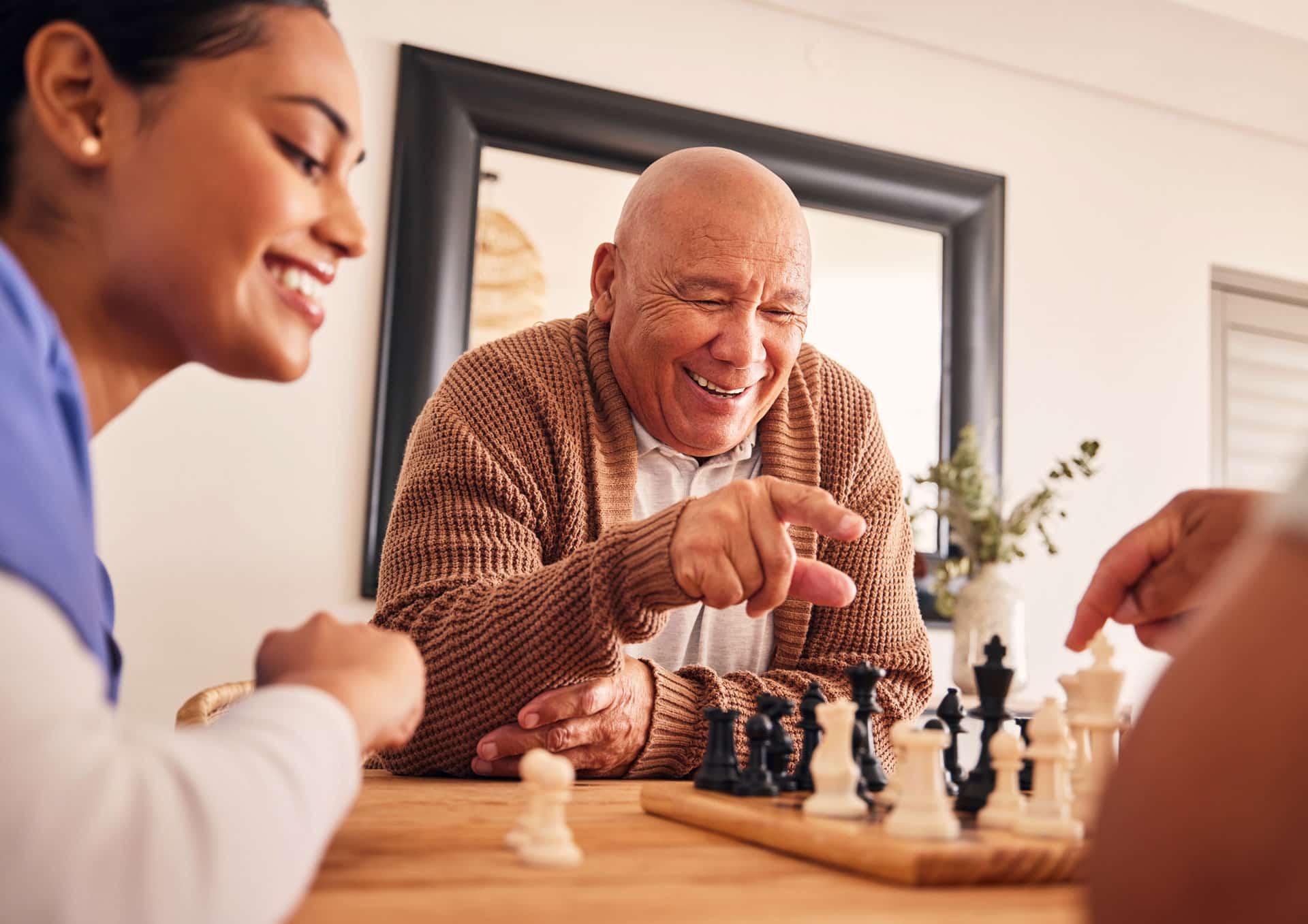 Senior man playing chess at table